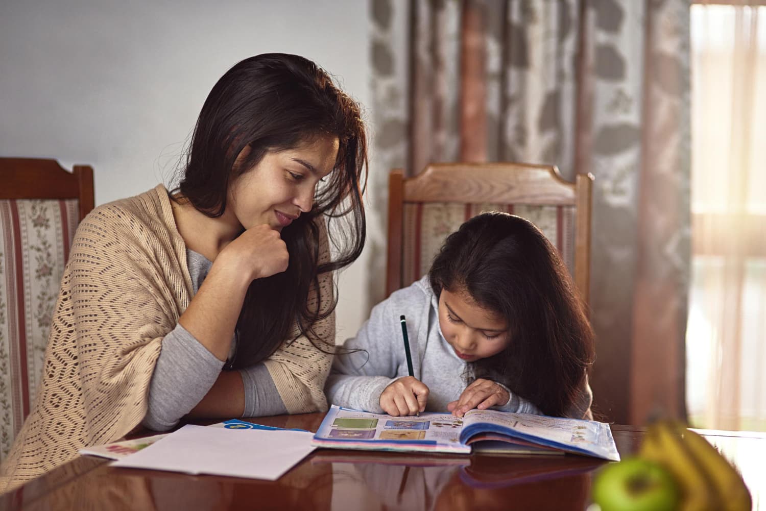 A parent at home, checking their child's homework on their phone